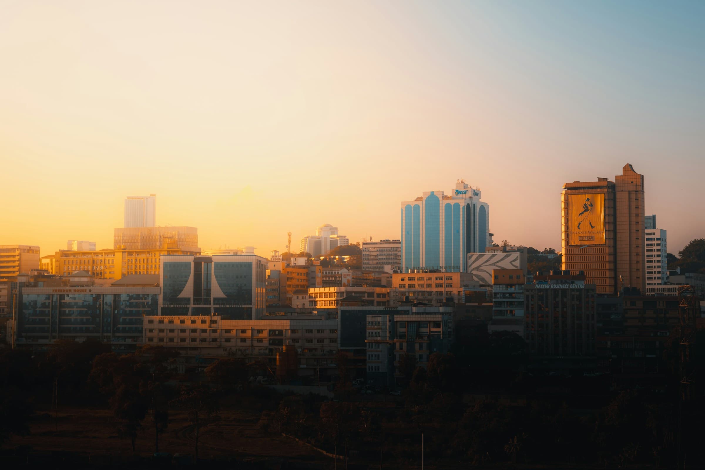 Modern Kampala skyline at sunset with commercial buildings and urban development